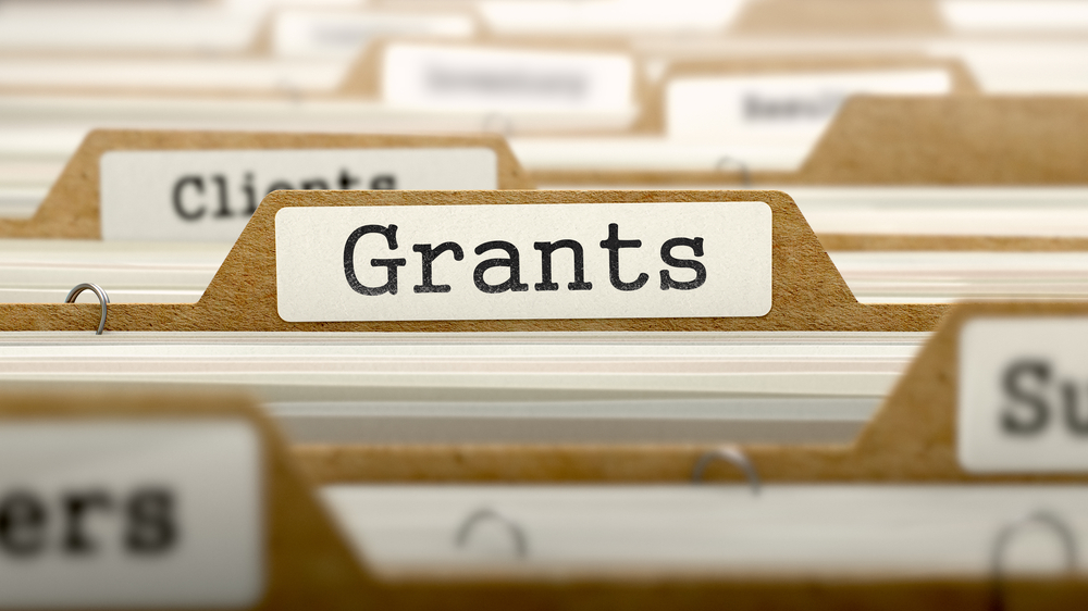 a file folder marked “grants”