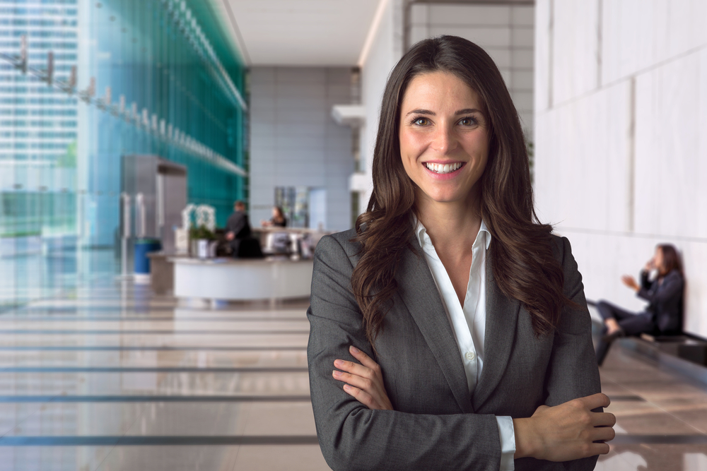 businesswoman stands in building lobby